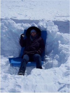 Katy Farness enjoys a cup of coffee in a snow pit