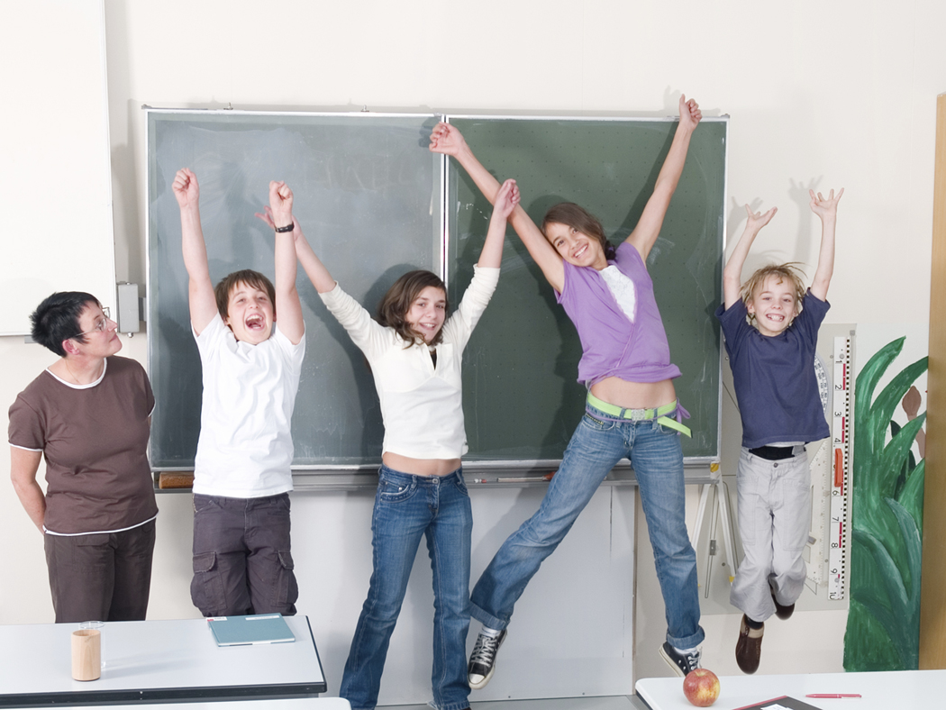 Children in front of chalkboard, excited