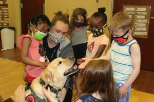 students with a dog from Buckeye Paws 